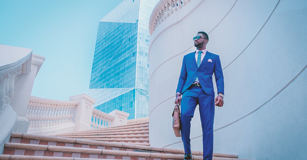 Stylish businessman walking up stairs with skyscraper backdrop in the UAE.